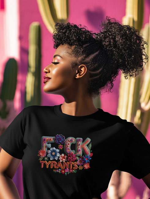 Black unisex T-shirt with bold floral embroidery-style text reading "F*ck Tyrants" in vibrant colors.
